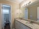 Bathroom with granite countertop, double sink vanity, framed mirror, and views of separate toilet at 2919 Alameda Trl, Decatur, GA 30034