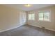This bedroom features plush carpeting, a double door closet, and two windows for natural light at 2919 Alameda Trl, Decatur, GA 30034