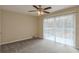 A cozy bedroom featuring plush carpet, a ceiling fan, and a sliding door to a deck at 2919 Alameda Trl, Decatur, GA 30034