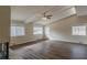 The spacious living room features a ceiling fan, hardwood floors and multiple windows at 2919 Alameda Trl, Decatur, GA 30034