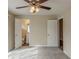 Main bedroom with carpet floors. A door opens to an en suite bathroom at 2919 Alameda Trl, Decatur, GA 30034