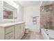 Basement bathroom with a shower/tub combo and tile surround at 70 Finch Forest Trl, Atlanta, GA 30327