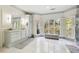Spa-like bathroom with marble floors, a large vanity, and windowed shower at 70 Finch Forest Trl, Atlanta, GA 30327