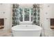 Elegant bathroom with a freestanding tub and tropical-themed decor at 70 Finch Forest Trl, Atlanta, GA 30327