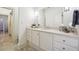 Bathroom with white cabinets, a large mirror, and a walk-in shower at 70 Finch Forest Trl, Atlanta, GA 30327