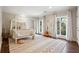 Bedroom with a canopy bed, wood floors, and large windows at 70 Finch Forest Trl, Atlanta, GA 30327