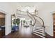 Grand entryway with sweeping staircase and stunning chandelier at 70 Finch Forest Trl, Atlanta, GA 30327