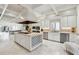 Open kitchen features a large island with wine rack and stainless steel appliances at 70 Finch Forest Trl, Atlanta, GA 30327
