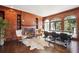 Home library with wood-paneled walls, built-in bookshelves, and a fireplace at 70 Finch Forest Trl, Atlanta, GA 30327