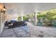 Covered patio with comfortable seating overlooking a landscaped yard at 70 Finch Forest Trl, Atlanta, GA 30327