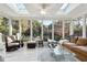 Bright sunroom with large windows, comfortable seating, and skylights at 70 Finch Forest Trl, Atlanta, GA 30327