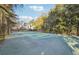 Private tennis court with surrounding trees and a house in the background at 70 Finch Forest Trl, Atlanta, GA 30327