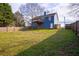 Large, grassy backyard with a wooden fence, perfect for outdoor activities and privacy at 1469 Harmony Grove Church Rd, Auburn, GA 30011