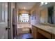 Serene bathroom featuring a soaking tub, granite countertops, and hanging plants at 1469 Harmony Grove Church Rd, Auburn, GA 30011
