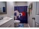 Cozy bathroom featuring a vibrant shower curtain and a white vanity at 1469 Harmony Grove Church Rd, Auburn, GA 30011