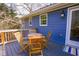 Wooden deck area featuring a table, chairs, and a view of surrounding trees at 1469 Harmony Grove Church Rd, Auburn, GA 30011