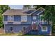 Charming two-story home with blue siding, updated windows, wooden deck, and a well-maintained lawn at 1469 Harmony Grove Church Rd, Auburn, GA 30011