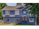 Charming two-story home with blue siding, updated windows, wooden deck, and a well-maintained lawn at 1469 Harmony Grove Church Rd, Auburn, GA 30011