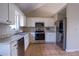 Bright kitchen featuring stainless steel appliances, white cabinets, and granite countertops at 1469 Harmony Grove Church Rd, Auburn, GA 30011