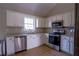 Bright kitchen featuring stainless steel appliances, white cabinets, and granite countertops at 1469 Harmony Grove Church Rd, Auburn, GA 30011