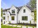Stunning two-story white brick home with black accents and landscaped lawn at 1211 Stephens Se St, Smyrna, GA 30080