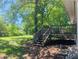 Large backyard with deck and mature trees at 158 Scarsdale Dr, Riverdale, GA 30274