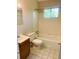 Bathroom with tub, toilet and wood vanity at 158 Scarsdale Dr, Riverdale, GA 30274