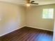 Bright bedroom with wood-look floors and ceiling fan at 158 Scarsdale Dr, Riverdale, GA 30274