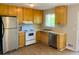 Kitchen with stainless steel appliances and wood cabinets at 158 Scarsdale Dr, Riverdale, GA 30274