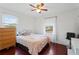 Bedroom with a double bed, dresser, and ceiling fan. Hardwood floors at 6625 Imperial Dr, Morrow, GA 30260