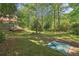 Secluded backyard with mature trees and plenty of space to enjoy nature at 959 Cedar Falls Sw Ct, Lilburn, GA 30047