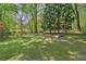 Lush backyard features mature trees and open space at 959 Cedar Falls Sw Ct, Lilburn, GA 30047
