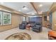 Finished basement showcasing two leather chairs, carpet, and a faux window to the outside at 959 Cedar Falls Sw Ct, Lilburn, GA 30047