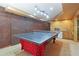 Basement ping pong table with brick accent wall, kitchenette, and modern lighting at 959 Cedar Falls Sw Ct, Lilburn, GA 30047