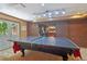 Basement ping pong table with brick accent wall and French doors to outside at 959 Cedar Falls Sw Ct, Lilburn, GA 30047