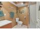 Rustic bathroom featuring a tiled floor, wood accents, and a glass door shower at 959 Cedar Falls Sw Ct, Lilburn, GA 30047