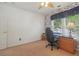 Bright bedroom featuring blue-patterned wallpaper, a comfortable chair, and built-in desk near the window at 959 Cedar Falls Sw Ct, Lilburn, GA 30047