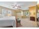 Cozy bedroom with windows, ceiling fan, fireplace, and rocking chair at 959 Cedar Falls Sw Ct, Lilburn, GA 30047