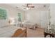 Sunlit bedroom with two twin beds, neutral walls and carpet, and ceiling fan at 959 Cedar Falls Sw Ct, Lilburn, GA 30047
