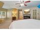 Comfortable bedroom featuring a fireplace, TV and a ceiling fan at 959 Cedar Falls Sw Ct, Lilburn, GA 30047