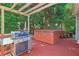 Relaxing deck with a hot tub, grill, and forest backdrop at 959 Cedar Falls Sw Ct, Lilburn, GA 30047