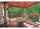 Inviting covered deck featuring a cozy seating area and a charming outdoor ambiance at 959 Cedar Falls Sw Ct, Lilburn, GA 30047