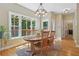 Sunny dining area with natural wood table and chairs, leading to outdoor deck and kitchen at 959 Cedar Falls Sw Ct, Lilburn, GA 30047