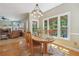 Inviting dining area with wood table, natural light, and adjacent living space with fireplace at 959 Cedar Falls Sw Ct, Lilburn, GA 30047