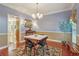 Cozy dining area features hardwood floors, a decorative rug, and a stylish chandelier at 959 Cedar Falls Sw Ct, Lilburn, GA 30047