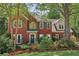 Charming two-story brick home with lush landscaping and a well-manicured lawn at 959 Cedar Falls Sw Ct, Lilburn, GA 30047
