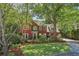 Charming brick home with lush landscaping, mature trees, and a well-maintained lawn at 959 Cedar Falls Sw Ct, Lilburn, GA 30047