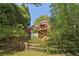 Charming home featuring a large deck with railings and lush, mature landscaping at 959 Cedar Falls Sw Ct, Lilburn, GA 30047