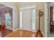 Bright and airy foyer with hardwood floors, coat rack, and sidelight windows at 959 Cedar Falls Sw Ct, Lilburn, GA 30047