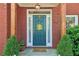Inviting front entrance with a decorative sunflower accent on the teal door at 959 Cedar Falls Sw Ct, Lilburn, GA 30047